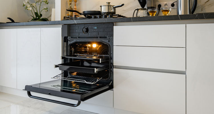 Technician repairing oven in modern Orlando kitchen