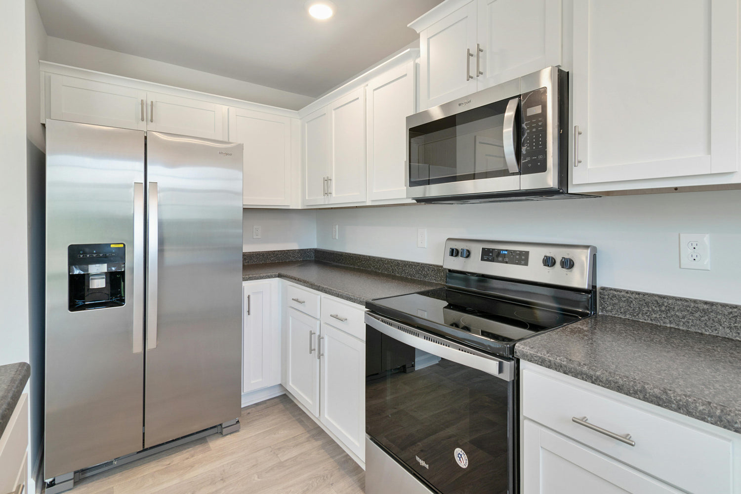 Technicians performing microwave repair in a home kitchen in Orlando, FL