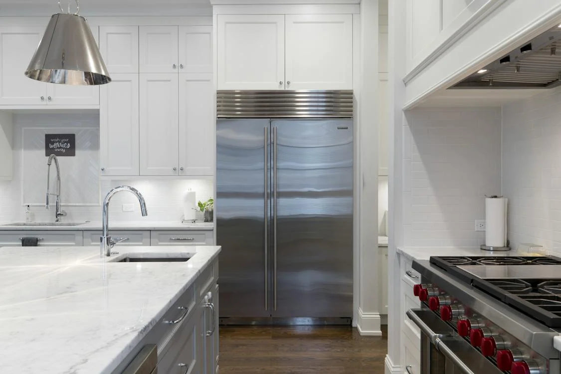 Technician fixing a broken refrigerator in Winter Park home