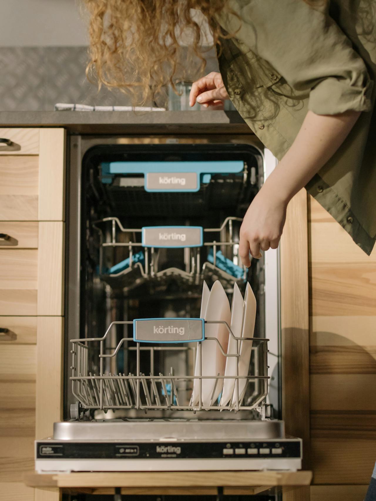 Professional technician installing a dishwasher near me.